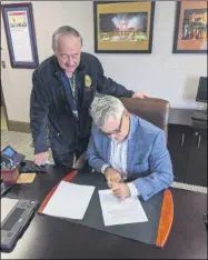  ?? PROVIDED PHOTO ?? Rensselaer County Executive Steve McLaughlin signs the First Responder Act.