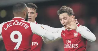  ??  ?? Mesut Ozil celebrates putting Arsenal 3-2 ahead with their third goal in five memorable minutes.