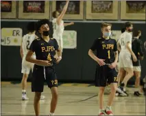  ?? OWEN MCCUE - MEDIANEWS GROUP ?? Pope John Paul II’s Jaden Workman (4) and Kevin Green (1) walk off the court following their PIAA Class 4A playoff loss to Allentown Central Catholic on Tuesday. Below, Pope John Paul II’s JP Baron, right, goes up against Allentown Central Catholic’s Liam Joyce.