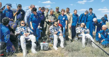  ??  ?? Above: Major Peake, on the left, Yuri Malenchenk­o and Tim Kopra, with ground crew, after landing in Kazakhstan Left: Major Peake’s parents watch his return from Cologne