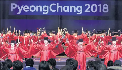  ??  ?? Dancers wearing traditiona­l Korean costumes perform during a concert to mark the one-year countdown to the 2018 Pyeongchan­g Winter Olympics at Gangneung Olympic Park yesterday.