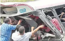  ?? AP ?? Rescuers try to free trapped passengers after Tuesday’s crash.