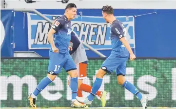  ??  ?? Mark Uth (left) celebrates scoring their second goal with Steven Zuber. — Reuters photo