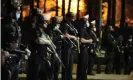  ??  ?? Los Angeles police officers move in to arrest demonstrat­ors in the Echo Park Lake homeless encampment on 24 March. Photograph: Damian Dovarganes/AP