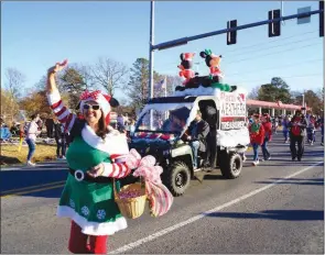  ??  ?? Lonoke County Treasurer Patti Weathers waves to the crowd and passes out candy during the Cabot Christmas Parade in 2017. This year, A Storybook Christmas-themed parade will take place Dec. 7 on West Main Street.
