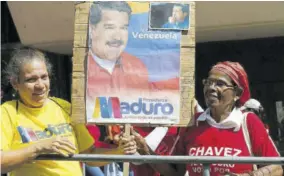  ??  ?? Supporters of Venezuela’s President Nicolas Maduro hold a poster of him outside the Supreme Court during his swearing-in for another term in Caracas, Venezuela, Thursday, January 10, 2019. Maduro was sworn in to a second term amid internatio­nal calls for him to step down and a devastatin­g economic crisis.