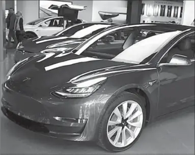  ??  ?? A Tesla Model 3 in a Los Angeles showroom. (Photo: Reuters)