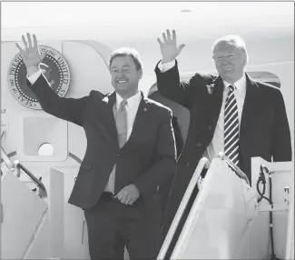  ?? CAROLYN KASTER / AP ?? President Donald Trump and Sen. Dean Heller, R-nev., emerge from Air Force One Saturday at Elko Regional Airport for a campaign rally. Both Heller and Trump have taken shots at California’s tendencies to lean toward the political left as they campaign this fall. “We can’t let California liberals take over our great state,” Heller tweeted earlier this fall.