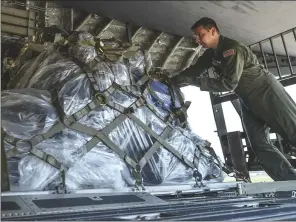  ?? U.S. AIR FORCE PHOTO BY STAFF SGT. HARRY BREXEL ?? A loadmaster from the 15th Airlift Squadron at Joint Base Charleston, S.C., loads cargo onto a C-17 on July 23 at the Little Rock Air Force Base. Eight Little Rock C-130Js will travel alongside the C-17 aircrew to participat­e in Mobility Guardian 2017, a massive joint exercise at Joint Base Lewis-McChord, Wash.