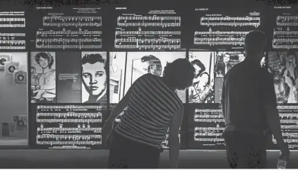  ??  ?? Candace Wilson, left, and Brad Flory, of Mason, Mich., look at photos of Elvis Presley during a tour of the Mississipp­i River Museum at Mud Island River Park on Aug. 12, 2017. YALONDA M. JAMES/THE COMMERCIAL APPEAL