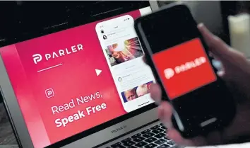  ?? AFP ?? An illustrati­on picture shows Parler logo displayed on a smartphone with its website in the background.