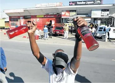  ?? Picture: Esa Alexander ?? People queue for liquor in Nyanga, Cape Town, as lockdown restrictio­ns on the purchase of alcohol were lifted this week. Within days, hospitals began to see a rise in victims of violence and car crashes related to drinking.