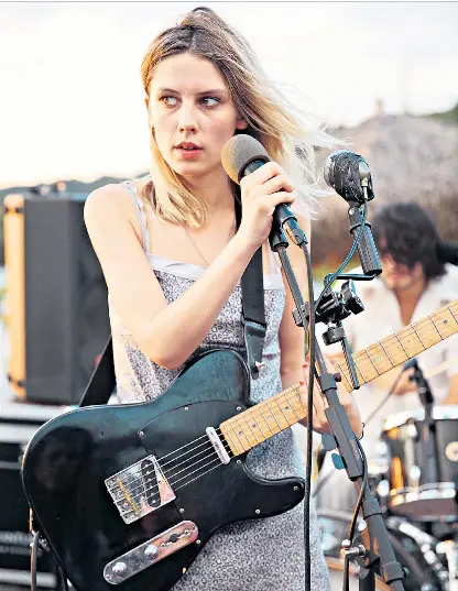  ??  ?? Role play: Rowsell above and, left, with Wolf Alice band members Joff Oddie, Joel Amey and Theo Ellis Rowsell admits that her open mic stage debut did not go well: ‘I literally couldn’t play the guitar and sing at the same time’