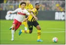  ?? AP PHOTO/MARTIN MEISSNER ?? Borussia Dortmund’s Youssoufa Moukoko, right, challenges for the ball with Stuttgart’s Enzo Millot during the German Bundesliga soccer match Oct. 22.