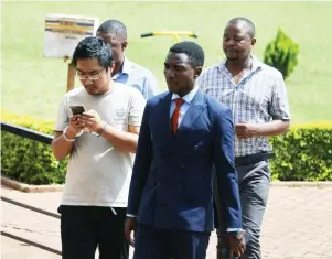  ?? ?? Meng Dong (34), who allegedly used a borrowed vehicle worth US$98 000 as collateral for a loan, arrives at the Harare Magistrate­s Court yesterday