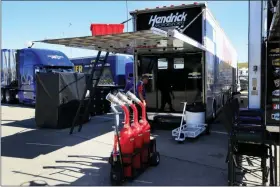  ?? ORLIN WAGNER — THE ASSOCIATED PRESS ?? A crew member for JTG Daugherty Racing enters a back up hauler from Hendrick Motorsport­s during practice for a NASCAR Cup Series auto race at Kansas Speedway in Kansas City, Kan., Friday. The JTG race team had to switch haulers after an accident on the way to Kansas Speedway rendered their hauler unusable.