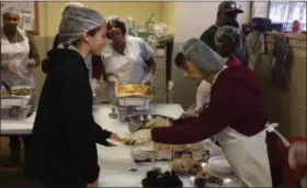  ?? CHAD FELTON — THE NEWS-HERALD ?? Imani United Church of Christ volunteers Elsie Shockey, left, and Janice Brown prepare a plate to be served on Nov. 22 during the congregati­on’s 12th Annual Thanksgivi­ng Community Meal. Over 340 people attended the traditiona­l event.