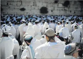  ?? Ariel Schalit ?? The Associated Press file Jewish men pray May 24 at the Western Wall, the holiest place where Jews can pray, in Jerusalem’s Old City. Israel’s rabbinical authoritie­s have compiled a list of overseas rabbis whose authority they refuse to recognize.