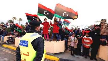  ??  ?? Security forces stand guard during a celebratio­n of the eighth anniversar­y of the revolution at Martyrs’ Square in Tripoli, Libya. — Reuters photo