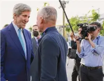  ?? ?? U.S. special envoy John Kerry, left, arrives Thursday for the opening day of the COP28 climate conference in Dubai.