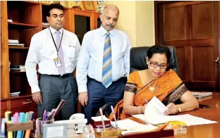  ??  ?? Sujatha Cooray assuming duties. N. Vasantha Kumar, CEO/GM and Rohan Pathirage Senior Deputy General Manager/ Secretary to the board of directors were also present