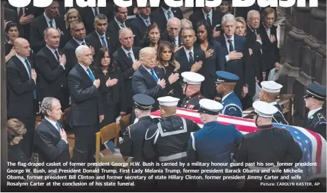  ?? Picture: CAROLYN KASTER, AP ?? The flag-draped casket of former president George H.W. Bush is carried by a military honour guard past his son, former president George W. Bush, and President Donald Trump, First Lady Melania Trump, former president Barack Obama and wife Michelle Obama, former president Bill Clinton and former secretary of state Hillary Clinton, former president Jimmy Carter and wife Rosalynn Carter at the conclusion of his state funeral.