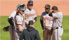  ?? GENE J. PUSKAR/AP ?? Orioles reliever Yennier Cano, right, gets a visit from manager Brandon Hyde in the ninth inning.