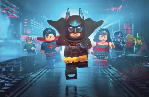  ??  ?? Lego Batman (voiced by Will Arnett) and members of the Justice League fight crime in the animated adventure “The LEGO Batman Movie,” from Warner Bros.