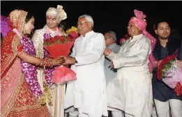  ?? — PTI ?? Bihar chief minister Nitish Kumar greets RJD chief Lalu Prasad Yadav’s son Tej Pratap during the wedding ceremony at Veterinary College Ground in Patna on Saturday.