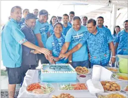  ?? Picture: JONA KONATACI ?? Fiji Fish Marketing Group Ltd business manager Matthew Southwick, left, cuts their Fiji Day celebratio­n cake with staff members in Lami yesterday.