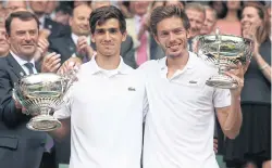  ?? AFP ?? France’s Pierre-Hughes Herbert, left, and Nicolas Mahut.