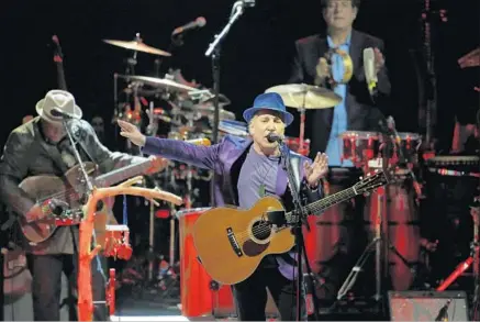 ?? Katie Falkenberg Los Angeles Times ?? STILL TOURING after all these years: A dapper Paul Simon performs at the Hollywood Bowl in June, in support of his latest album.
