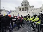  ?? JULIO CORTEZ — THE ASSOCIATED PRESS ?? Supporters of President Donald Trump try to break through a police barrier at the Capitol in Washington.