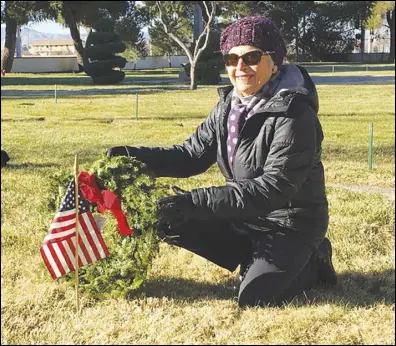  ?? ALLISON GATLIN/VALLEY PRESS FILES ?? Lynn DuPratt lays the ceremonial first wreath on the grave of former Antelope Valley Press editor Vern Lawson Sr. during last year’s Wreaths Across America at Lancaster Cemetery. Lawson was a World War II veteran. The Wreaths Across America is taking place again, this year.