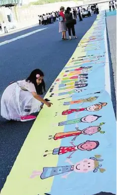  ?? Arshad Ali/Gulf News ?? Pride of Dubai The eight-month campaign to make the record painting was spearheade­d by Al Tayer Group and Dubai Autism Centre.