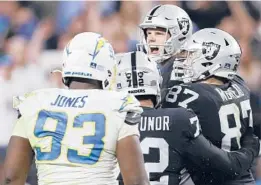  ?? ELLEN SCHMIDT/AP ?? The Raiders’ Daniel Carlson, center, celebrates after his game-winning field goal Sunday night against the Chargers. The Raiders will face the Bengals in the playoffs.