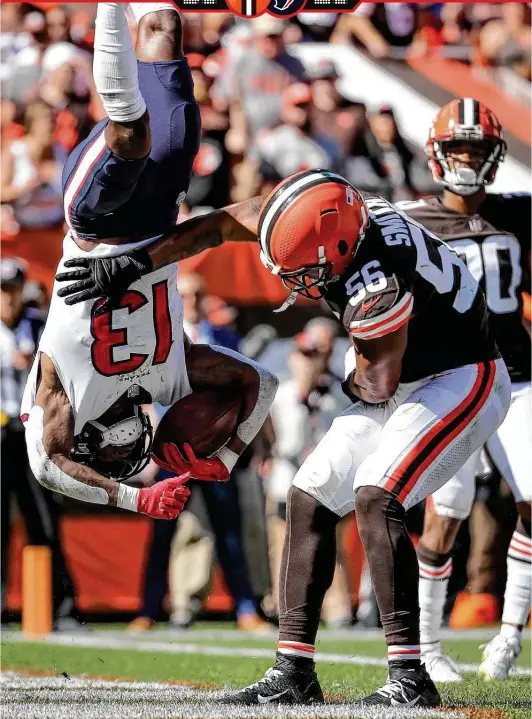  ?? Brett Coomer / Staff photograph­er ?? Browns linebacker Malcolm Smith upends Texans wide receiver Brandin Cooks as he scores on a 2-yard reception. Crooks had nine catches for 78 yards.
