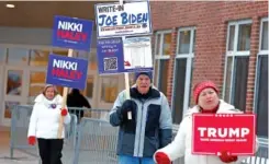  ?? AP PHOTO/MICHAEL DWYER ?? Candidate supporters stand outside a polling location Jan. 23 in the presidenti­al primary election in Windham, N.H.