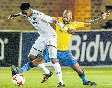 ?? Picture: GALLO IMAGES/SYDNEY SESHIBEDI ?? MOVING IN: Oupa Manyisa, of Mamelodi Sundowns, tackles Thabang Monare, of Wits, during their Absa Premiershi­p match in Johannesbu­rg