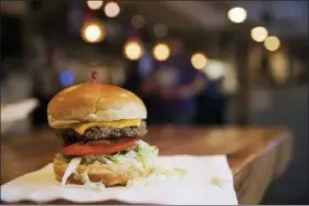  ?? RYAN SODERLIN — THE WORLD-HERALD VIA AP, FILE ?? The Impossible Burger at Stella’s, in Bellevue, Neb., is made from plant protein. As companies look to lessen Americans’ reliance on animals for food, the term “plant based” is replacing “vegan” and “vegetarian” because of the unappetizi­ng and polarizing associatio­ns the v-words might have.