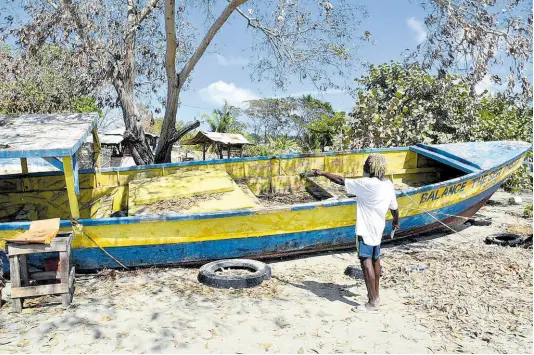  ?? ?? Fisherman Aston Edwards pointing to damaged sections of his boat.