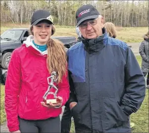  ?? SUBMITTED PHOTO/CAROL CAMPBELL ?? Track and field coach Angus Beaton of Mabou is shown with athlete Maddie Campbell of Baddeck following the regional championsh­ip at Dalbrae Academy in Mabou in May 2014.