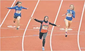  ??  ?? Terengganu’s Azreen Nabila Alias wins the women’s 100m in a record time of 11.81sec. — Bernama photo