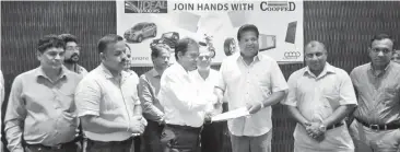  ??  ?? Nalin Welgama – Chairman Ideal Motors and Deputy Chairman, Aravinda De Silva exchanging the COOPFED agreement with members of COOPFED