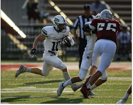  ?? TIM PHILLIS – FOR THE NEWS-HERALD ?? Tyler Seacrist of Lake Catholic runs for yardage in the Cougars’ season-opening loss to Dover on Aug. 19.