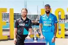  ?? — AFP photo ?? New Zealand captain Williamson (left) with India captain Pandya pose with the T20 trophy two days out from the first T20 match during a standup on the Water Front in Wellington.