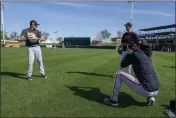  ?? MORRY GASH — THE ASSOCIATED PRESS ?? The San Francisco Giants' Sean Manaea takes pictures of Taylor Rogers and Tyler Rogers during a spring training workout Saturday in Scottsdale.