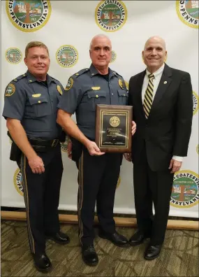  ?? SUBMITTED PHOTO ?? Lt. James Audette, from left, Coatesvill­e Police Chief Jack Laufer and District Attorney Tom Hogan pose together with the District Attorney’s commendati­on award on Monday night.