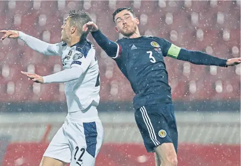  ??  ?? DETERMINED LEADER: Scotland captain Andy Robertson in an aerial challenge with Serbia’s Darko Lazovic.