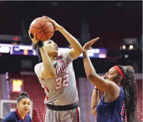  ??  ?? New Mexico’s Antonia Anderson shoots over Fresno State’s Wytalla Motta on Tuesday. Anderson had 15 points and seven rebounds in UNM’s loss.